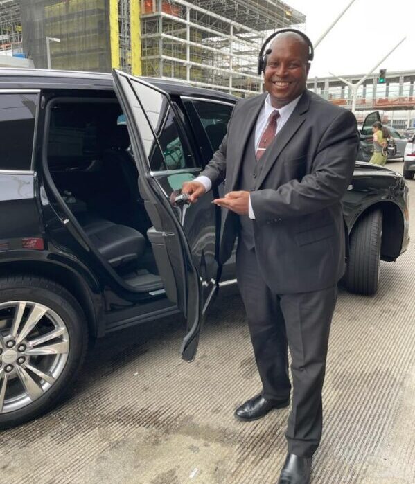 Founder Patrick Paige welcoming a client to the private vehicle for Thousand Oaks airport transportation