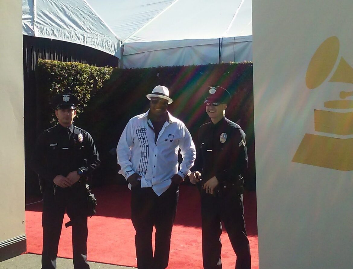 Founder Patrick W. Paige with local police officers at the Grammy Awards, thanking them after a group featuring his son as a member was nominated.