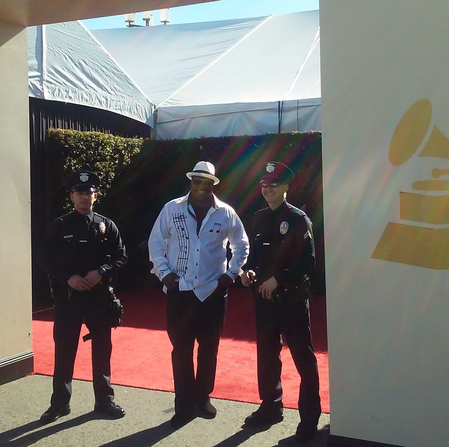 Founder Patrick W. Paige with local police officers at the Grammy Awards, thanking them after a group featuring his son as a member was nominated.