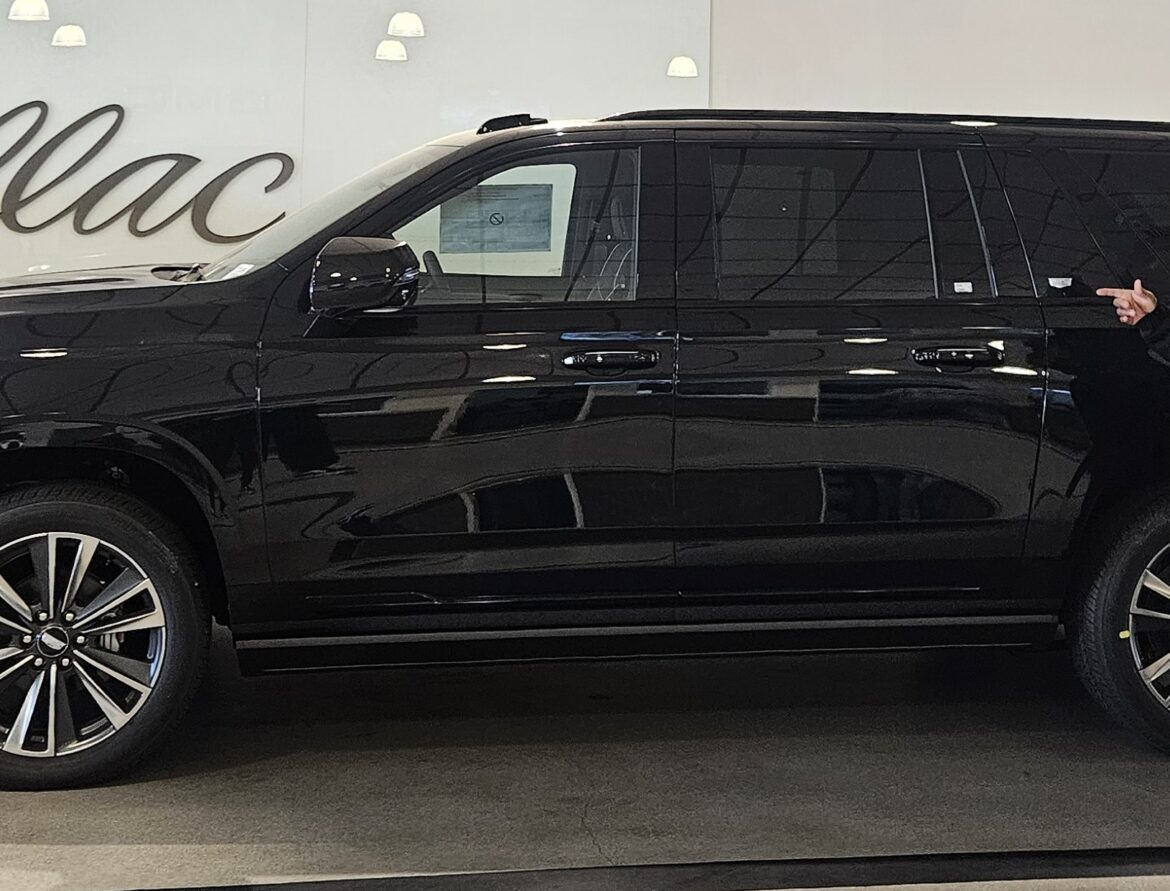 Patrick Paige purchasing a new Cadillac Escalade Sport for his Newport Beach executive car service